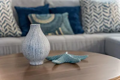 a vase and two stars on a table in a living room at Urban retreat- Quiet comfy 1 bedroom condo near LAX in Los Angeles