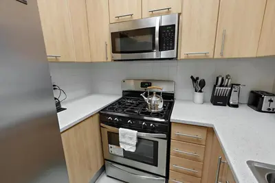 a kitchen with a stove and a microwave at Urban retreat- Quiet comfy 1 bedroom condo near LAX in Los Angeles