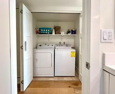 a laundry room with a washer and dryer at Malibu Waterfront Gallery with Private Beach Access in Malibu Beach
