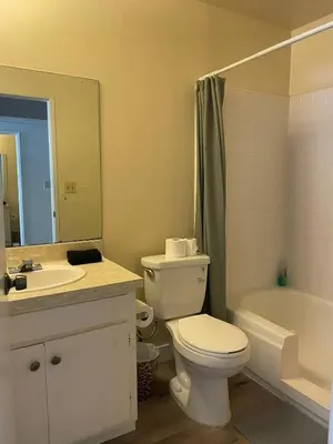 a bathroom with a toilet and a sink and a tub at Modern Apart in Beverly Hills in Los Angeles