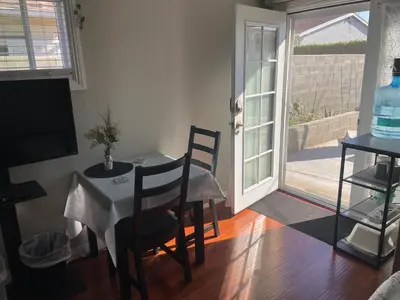 a dining room with a table and chairs and a sliding glass door at The stay go in Gardena