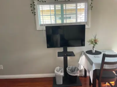 a flat screen tv on a wall in a living room at The stay go in Gardena