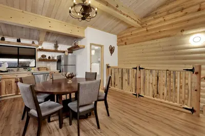 a kitchen and dining room with a table and chairs at Ours De Ski Chateau at Snow Summit - Big Bear Basecamp Resort Condo w/ Hot Tub in Big Bear Lake
