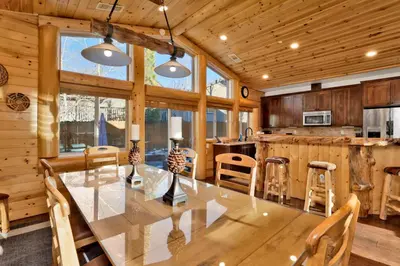 a dining room and kitchen with a table and chairs at Morning Star Log Cabin at Big Bear Ultra-Modern Castle Glen Mountain Chalet in Big Bear Lake