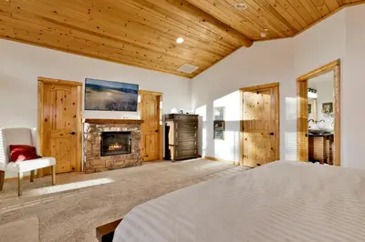 a bedroom with a bed and a fireplace at Morning Star Log Cabin at Big Bear Ultra-Modern Castle Glen Mountain Chalet in Big Bear Lake