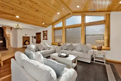 a living room with white furniture and wooden ceilings at Morning Star Log Cabin at Big Bear Ultra-Modern Castle Glen Mountain Chalet in Big Bear Lake
