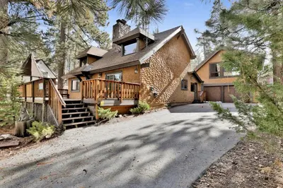 a large brick house with a porch and a driveway at Crystal Pines at Big Bear Lake Walk to Boulder Bay Park Family-Friendly Retreat in Big Bear Lake