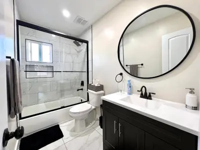 a bathroom with a sink and a mirror at Golden Downey Designer Abode - Poolside Suite in Downey