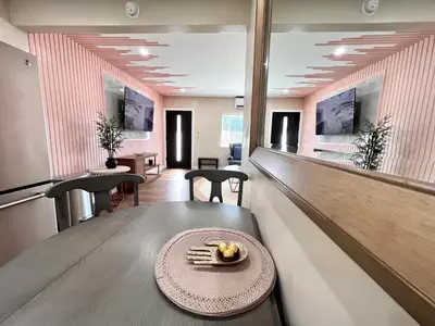 a restaurant with a table with a plate of food on it at Golden Downey Designer Abode - Poolside Suite in Downey