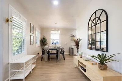 a living room with a table and a dining room at Elegant 3 Bedroom 2 Bathroom With EV Charging Near Santa Anita in Duarte