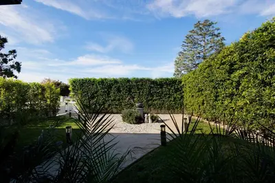 a garden with hedges and a walkway at Elegant 3 Bedroom 2 Bathroom With EV Charging Near Santa Anita in Duarte