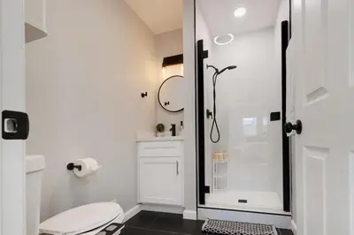 a white bathroom with a shower and a toilet at Elegant 3 Bedroom 2 Bathroom With EV Charging Near Santa Anita in Duarte