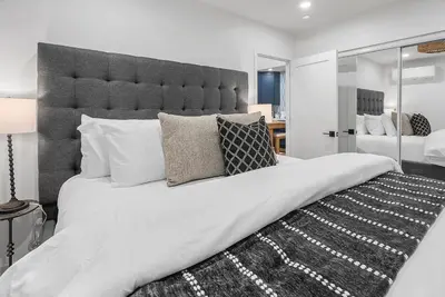 a large white bed with a large headboard and pillows at New 1 BR, King Bed, Laundry In-Unit, Parking in Los Angeles