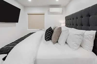a bedroom with a large white bed with white pillows at New 1 BR, King Bed, Laundry In-Unit, Parking in Los Angeles