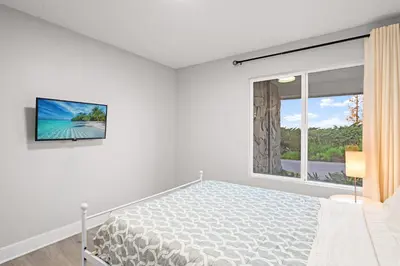 a white bedroom with a bed and a window at Serene Hilltop Oasis Above the City w Private Pool in Hacienda Heights