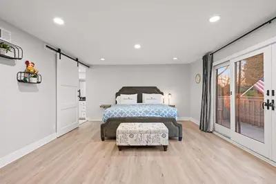 a bedroom with a bed and a large window at Serene Hilltop Oasis Above the City w Private Pool in Hacienda Heights