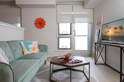 a living room with a couch and a table at Coastal Luxe | Walk to Pier + Free Parking in Los Angeles