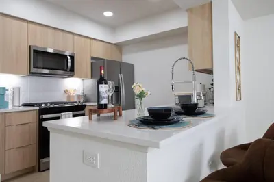 a kitchen with a counter with two bowls on it at High-End 1BR Oasis | Walk to Ocean & 3rd Street in Los Angeles