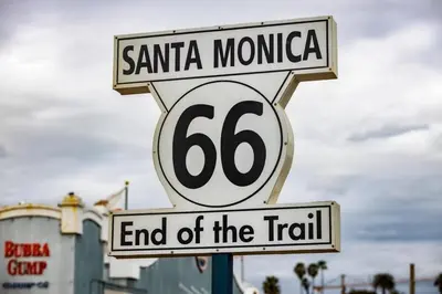 a street sign for santa monica and end of the trail at High-End 1BR Oasis | Walk to Ocean & 3rd Street in Los Angeles