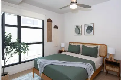 a bedroom with a bed and a ceiling fan at * Soho Vibes In The Heart Of Santa Monica * in Los Angeles