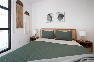 a bedroom with a green bed with two pillows at * Soho Vibes In The Heart Of Santa Monica * in Los Angeles