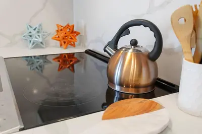 a tea kettle sitting on top of a stove at Laugh in the Lap of Luxury In SM * FREE Parking * in Los Angeles