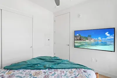 a bedroom with a tv hanging on the wall at * Breathtaking Place In Santa Monica's Heart * in Los Angeles