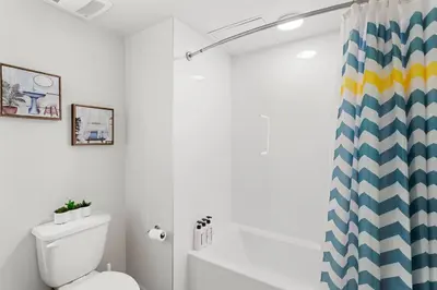 a bathroom with a toilet and a shower curtain at * Breathtaking Place In Santa Monica's Heart * in Los Angeles
