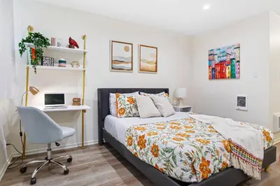 a bedroom with a bed and a desk and a computer at Santa Monica's Prestige Place *Steps To The Beach* in Los Angeles