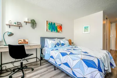 a bedroom with a bed and a desk and a computer at Oceanview Penthouse Luxury Stay Steps To the Beach in Los Angeles