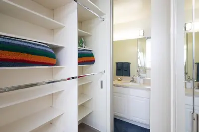 a walk in closet with a sink and a mirror at Wake Up to Waves – Beachside Bliss In Santa Monica in Los Angeles