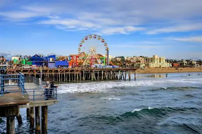 a pier with a ferris wheel on the beach at SoCal Luxurious Apt Steps To The Beach & Pier in Los Angeles