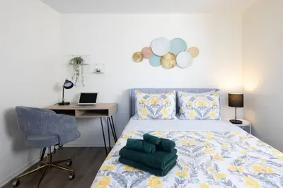 a bedroom with a bed and a desk with a laptop at * Prime Location Studio Near Santa Monica Pier * in Los Angeles