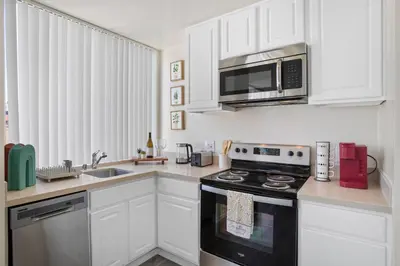 a kitchen with white cabinets and a stove and microwave at Luxurious &Spacious 1Bed 1Bath Apt In Santa Monica in Los Angeles