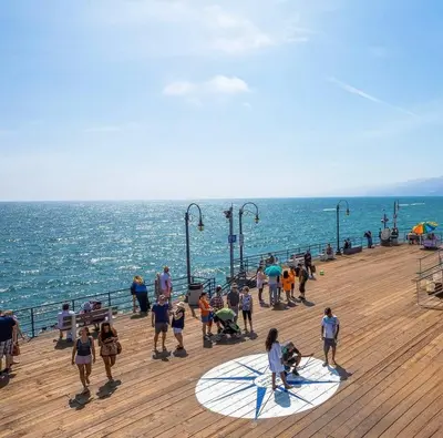a group of people standing on a pier near the ocean at Beachside Beauty Steps To The Beach & Restaurants in Los Angeles
