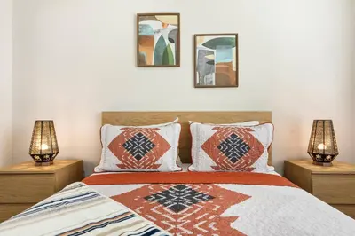 a bedroom with a bed with pillows and two lamps at 5 Star 1BR Apartment w/ Free Parking & Fast WiFi in Los Angeles
