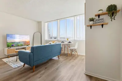 a living room with a blue chair and a table at 5-star West Hollywood Living | Modern & Central in Los Angeles