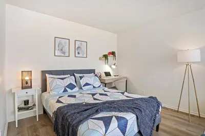 a bedroom with a bed and a desk with a lamp at 5-star West Hollywood Living | Modern & Central in Los Angeles