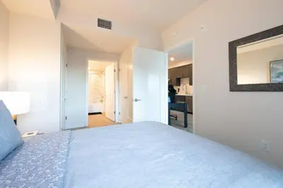 a bedroom with a bed and a mirror on the wall at 5-Star West Hollywood Living | Modern & Central in Los Angeles