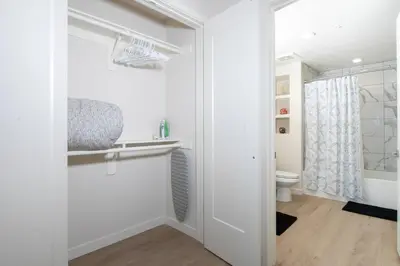 a white bathroom with a toilet and a sink at 5-Star West Hollywood Living | Modern & Central in Los Angeles