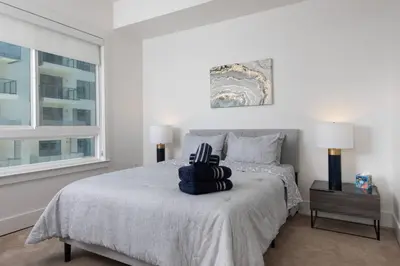 a bedroom with a bed and a window at West Hollywood Luxe | 2BR/2BA Resort Style in Los Angeles