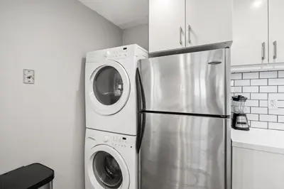 a kitchen with a refrigerator and a washer and dryer at Modern 1BR • Steps to Venice Beach in Los Angeles