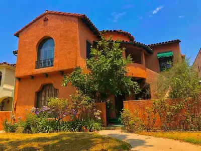 a large orange brick house with a tree at Cozy 3-Bedroom Home in K-town Los Angeles in Los Angeles