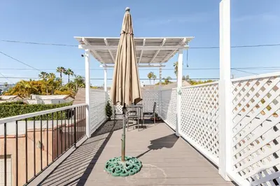 a patio with an umbrella and a table and chairs at Cozy 3-Bedroom Home in K-town Los Angeles in Los Angeles