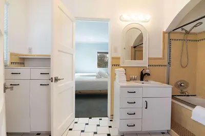 a white bathroom with a sink and a shower at Spacious 4BR Spanish Villa In Hancock Park in Los Angeles