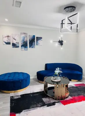 a living room with a blue couch and a table at Pasadena Charming Vacation Home with Hot Jacuzzi in Pasadena