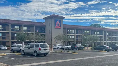 a large building with cars parked in a parking lot at Studio 6 Victorville Green Tree Bvld in Victorville