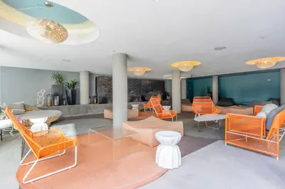 a living room with orange chairs and tables at Marina del Rey 2BR w Pool Gym nr beach LAX-636 in Los Angeles