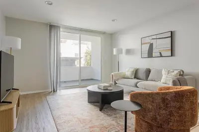 a living room with a couch and a table at Blueground Westwood balcony nr UCLA LAX-1397 in Los Angeles