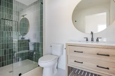 a bathroom with a toilet and a sink and a mirror at Blueground East Hollywood balcony nr Echo Park LAX-1336 in Los Angeles